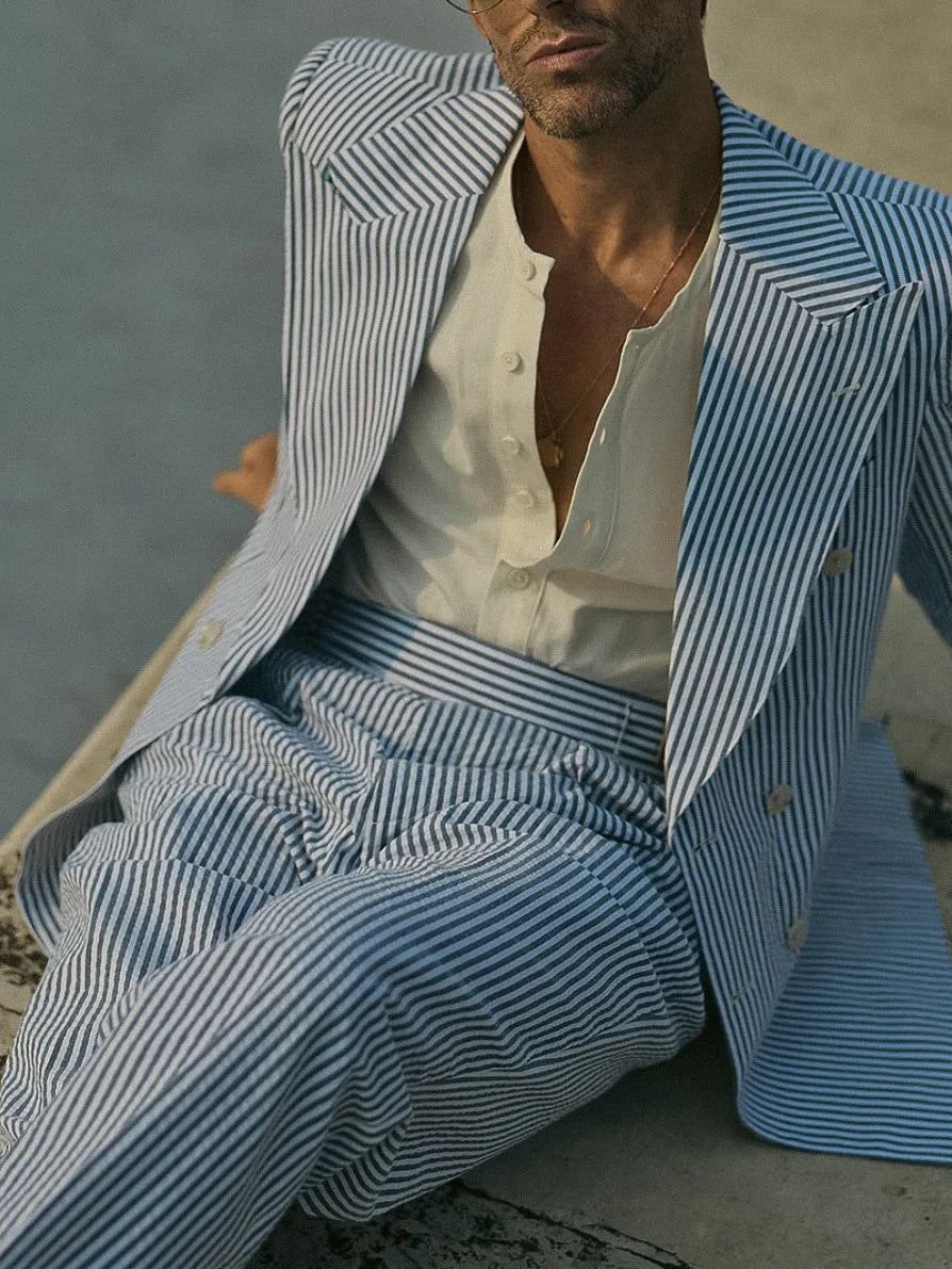 Blue and white striped polyester blazer and trousers suit set on a hanger