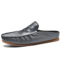 Men's black Gommino-style leisure semi-slippers with artificial PU upper and rubber sole on a white background.