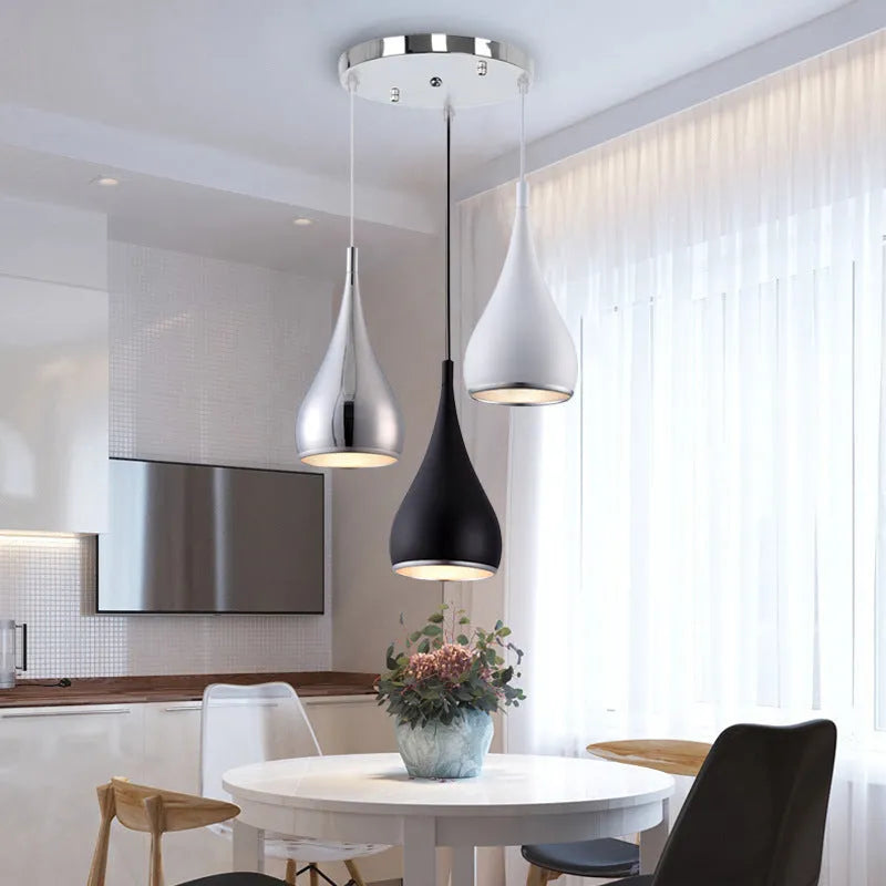 Minimalist iron chandelier in black finish with three bulb heads on a long platter base.