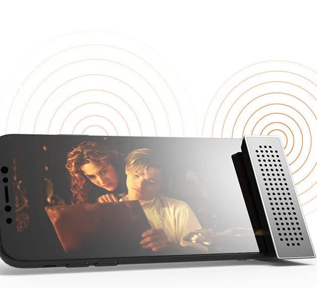 Mini black mobile phone amplifier bracket holding iPhone on desktop surface