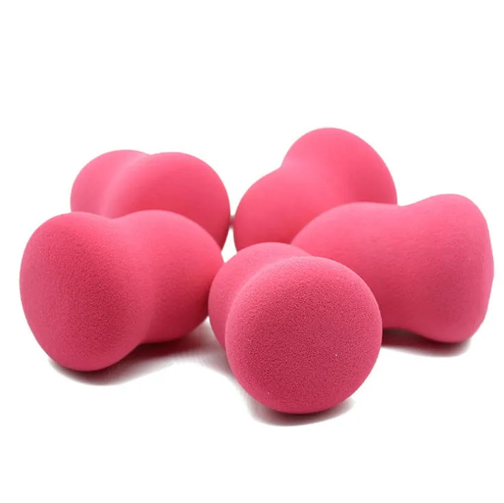 Pink cubic makeup sponge for foundation application, shown with dimensions 4cm by 4cm by 5.6cm.