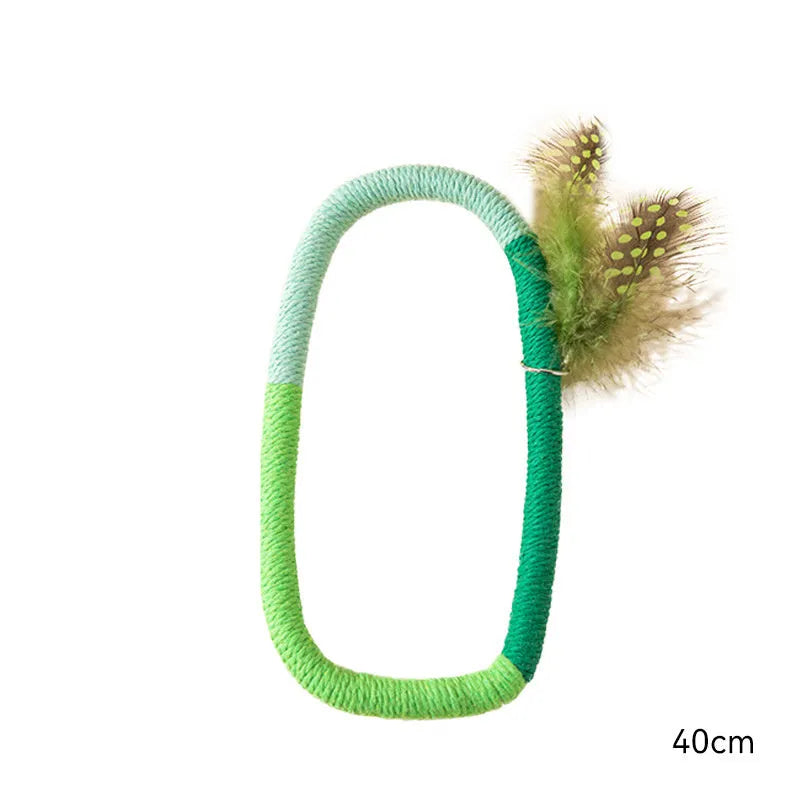Circular cotton rope cat toy with feathers and catnip measuring 25cm in green and purple colours