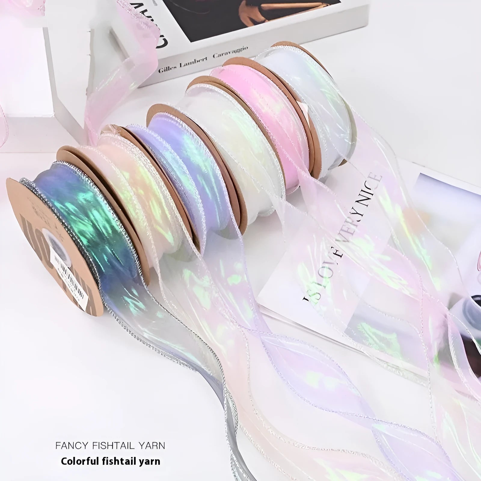 Roll of 4cm wide mesh fishtail yarn ribbon in colourful wave design for craft projects.