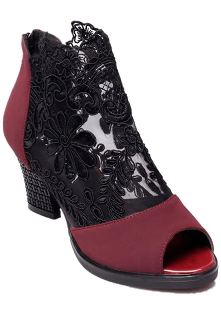 Black women's gladiator sandals with lace upper, square heel, zip closure, and peep toe.
