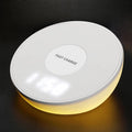 White wireless phone charger with clock display and control buttons on front