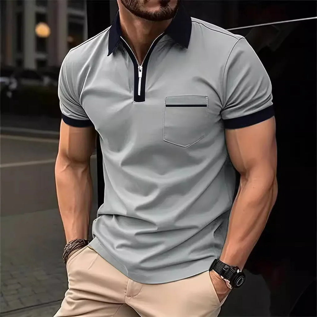Man wearing a loose-fit casual short-sleeved shirt with a chest pocket and zipper decoration details.