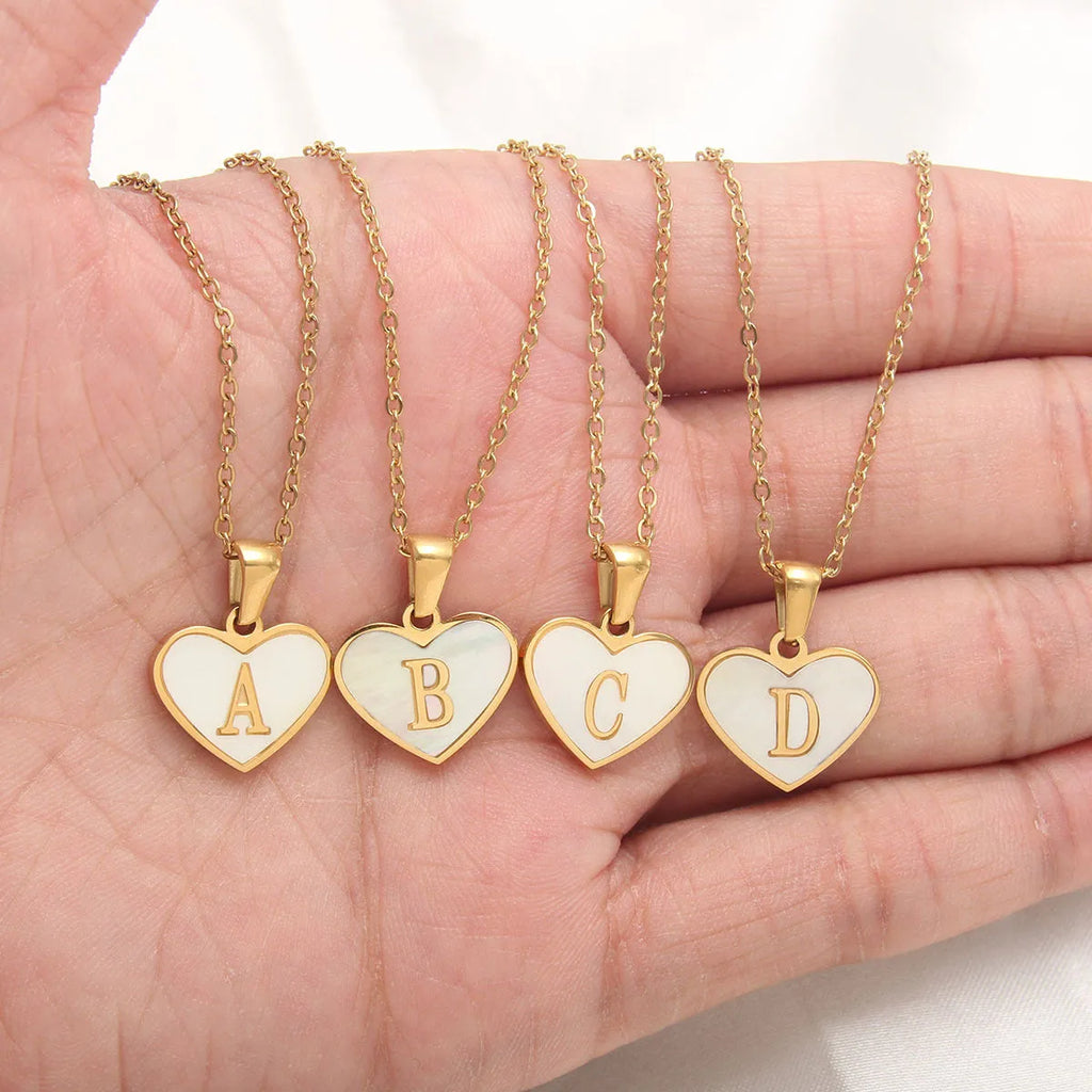 Gold plated chain necklace with a white shell heart-shaped pendant personalised with a single letter initial.