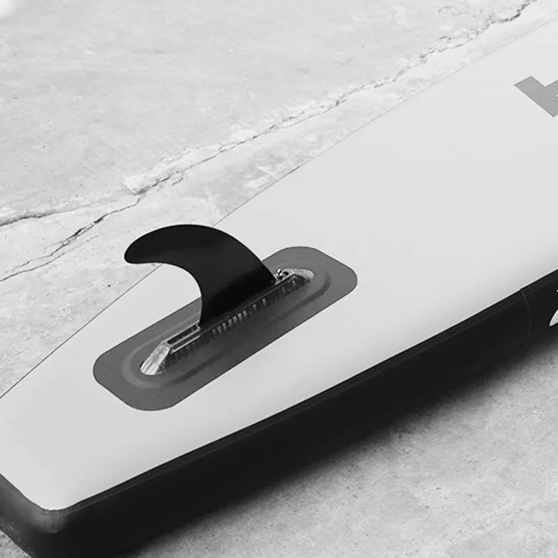 Heytur plastic SUP paddle with removable fish fin attachment on blade.