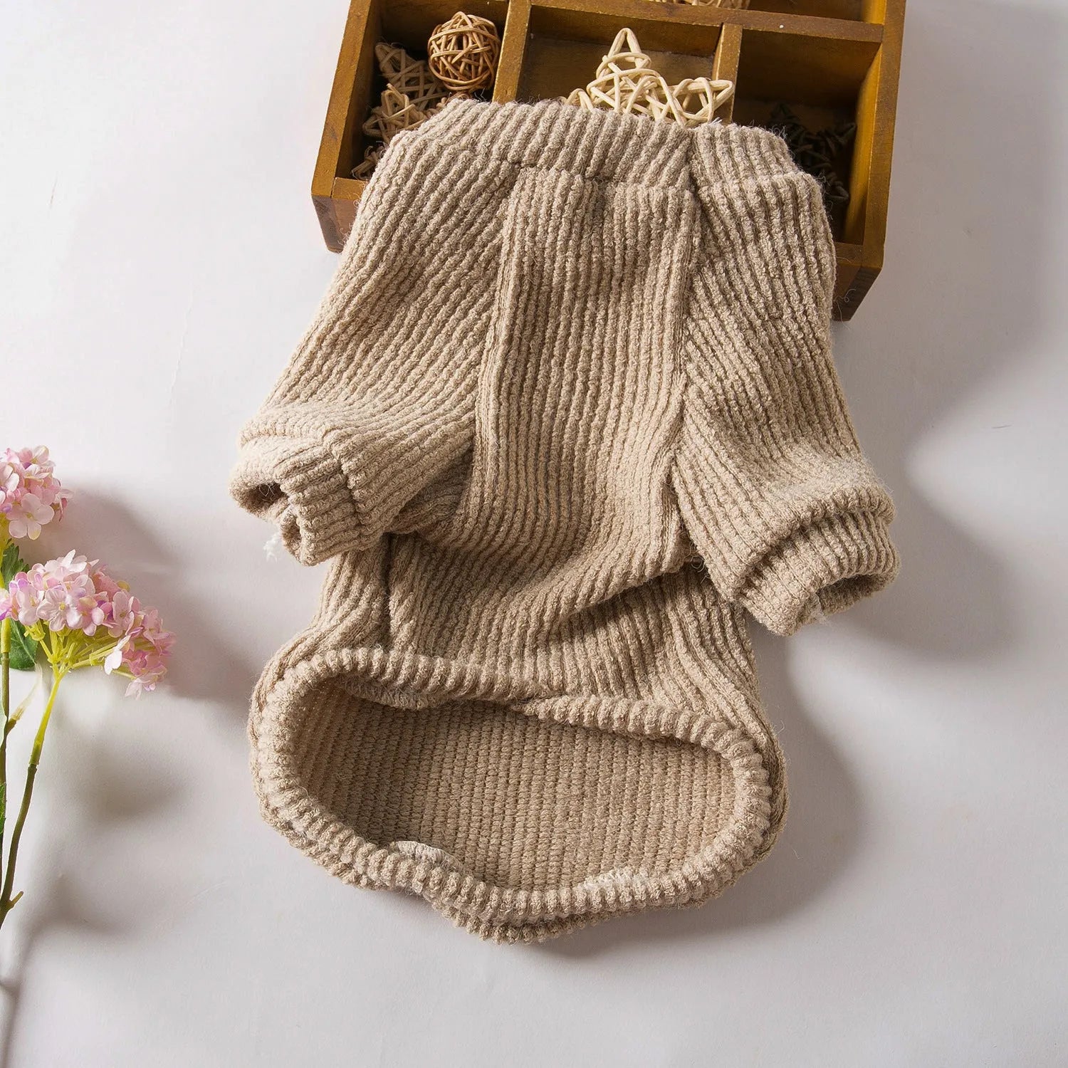 A brown cloth pullover sweater for a small dog on a white background.