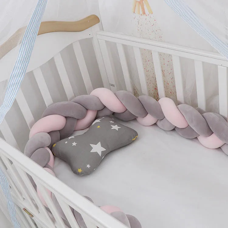 Braided knot style baby cot bumper in spandex crystal velvet fabric, shown in a light grey colour.