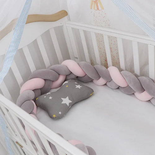 Braided knot style baby cot bumper in spandex crystal velvet fabric, shown in a light grey colour.