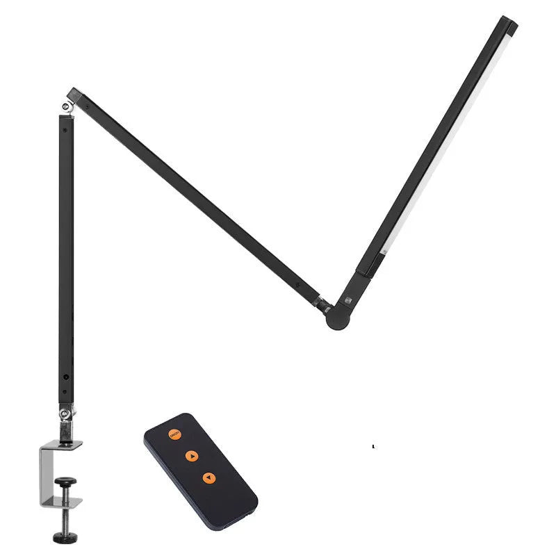 Black clip mount LED desk lamp with dimmer switch attached to study desk edge