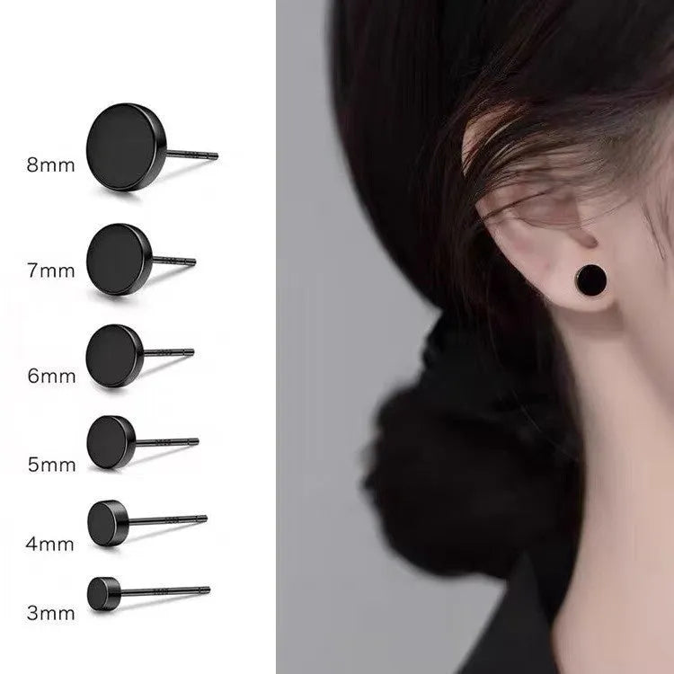 A pair of S999 sterling silver geometric round flat ear bone studs in black and silver finishes, showing size scale.