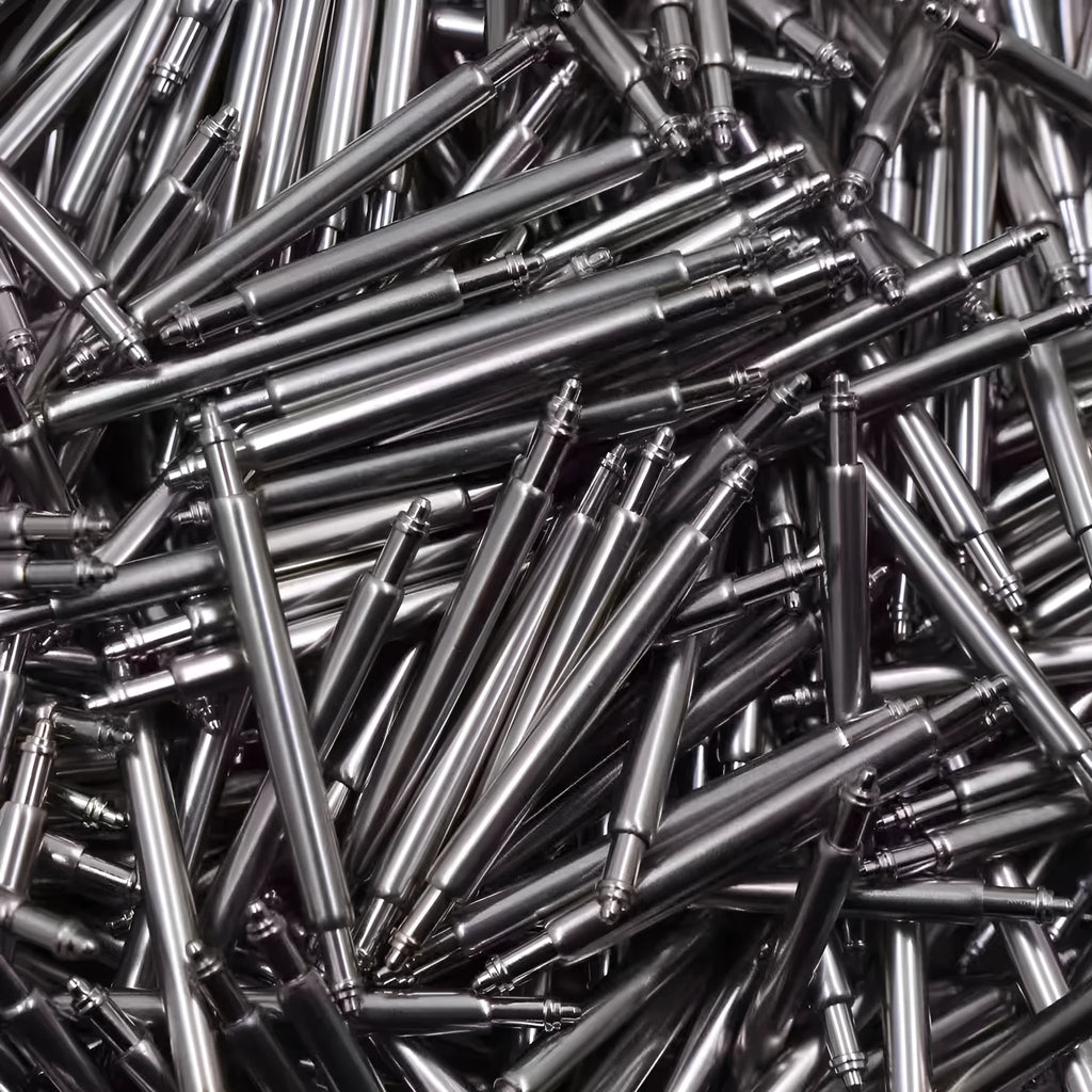 Bulk box of watch repair parts including bolts and springs in sizes 21mm to 26mm.