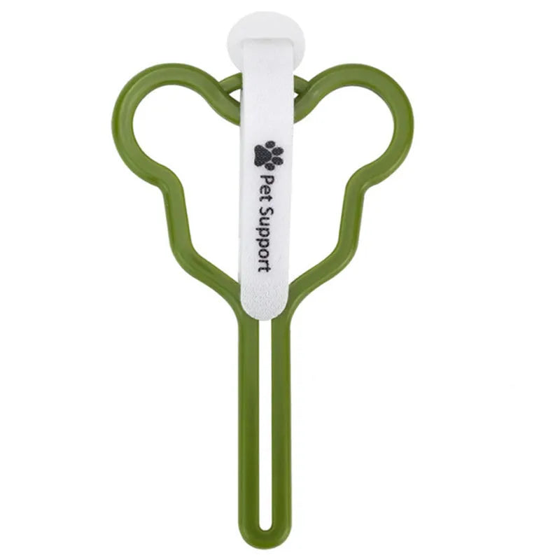 A hands-free dog poop bag holder with a fixed clip and adjustable black Velcro strap, shown attached to a dog lead.