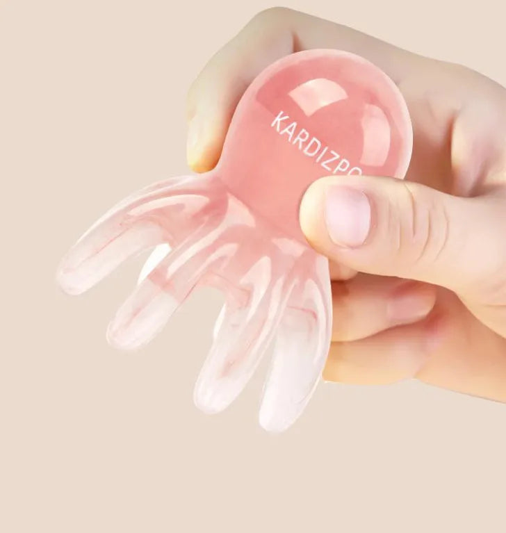 Small pink octopus-shaped massage comb made of natural resin with a storage bag.