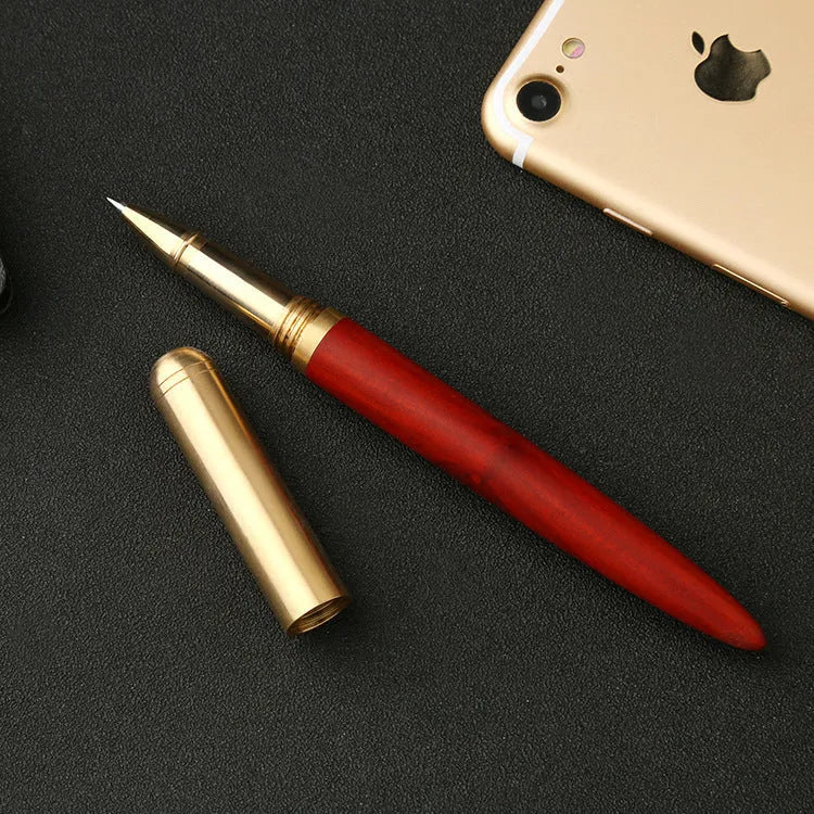 Brass sandalwood signature pen 14cm with wood barrel on a flat surface