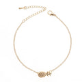 Close-up of a gold-colour alloy bracelet shaped like a pineapple on a wrist.