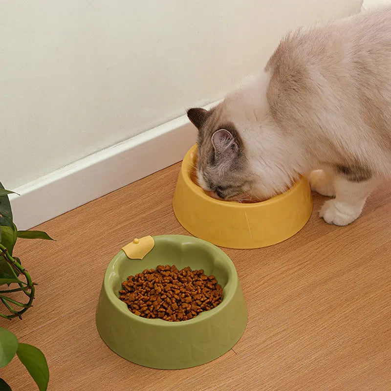 Green plastic double pet bowl for food and water with a flower-shaped, anti-tipping design.