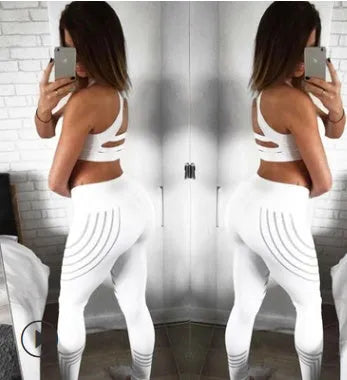 Women's black workout leggings with glowing print design and slim fit pencil pants silhouette