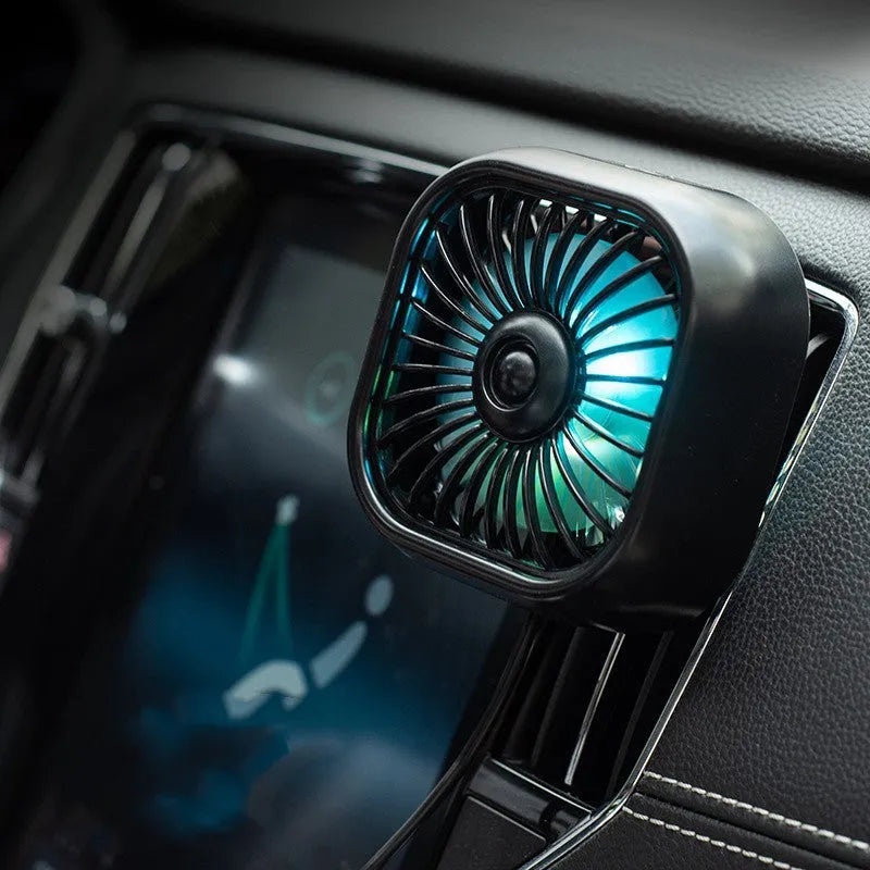 Compact USB car fan with three-speed buttons in black colour on vehicle dashboard