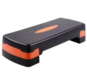 Grey Fit Step aerobic platform on a wooden floor, showing its non-slip textured surface.