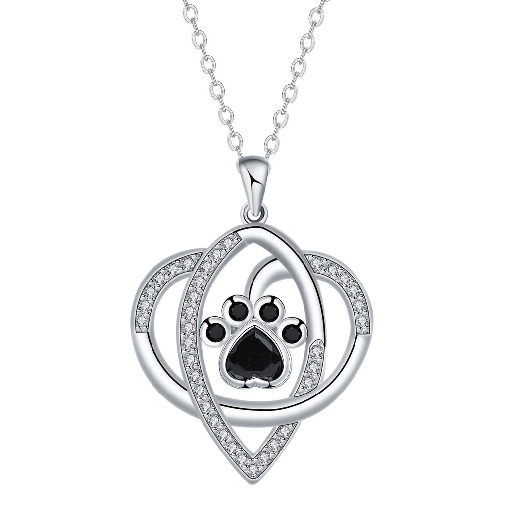 Close-up of dog and cat paw print pendant necklace with cross chain
