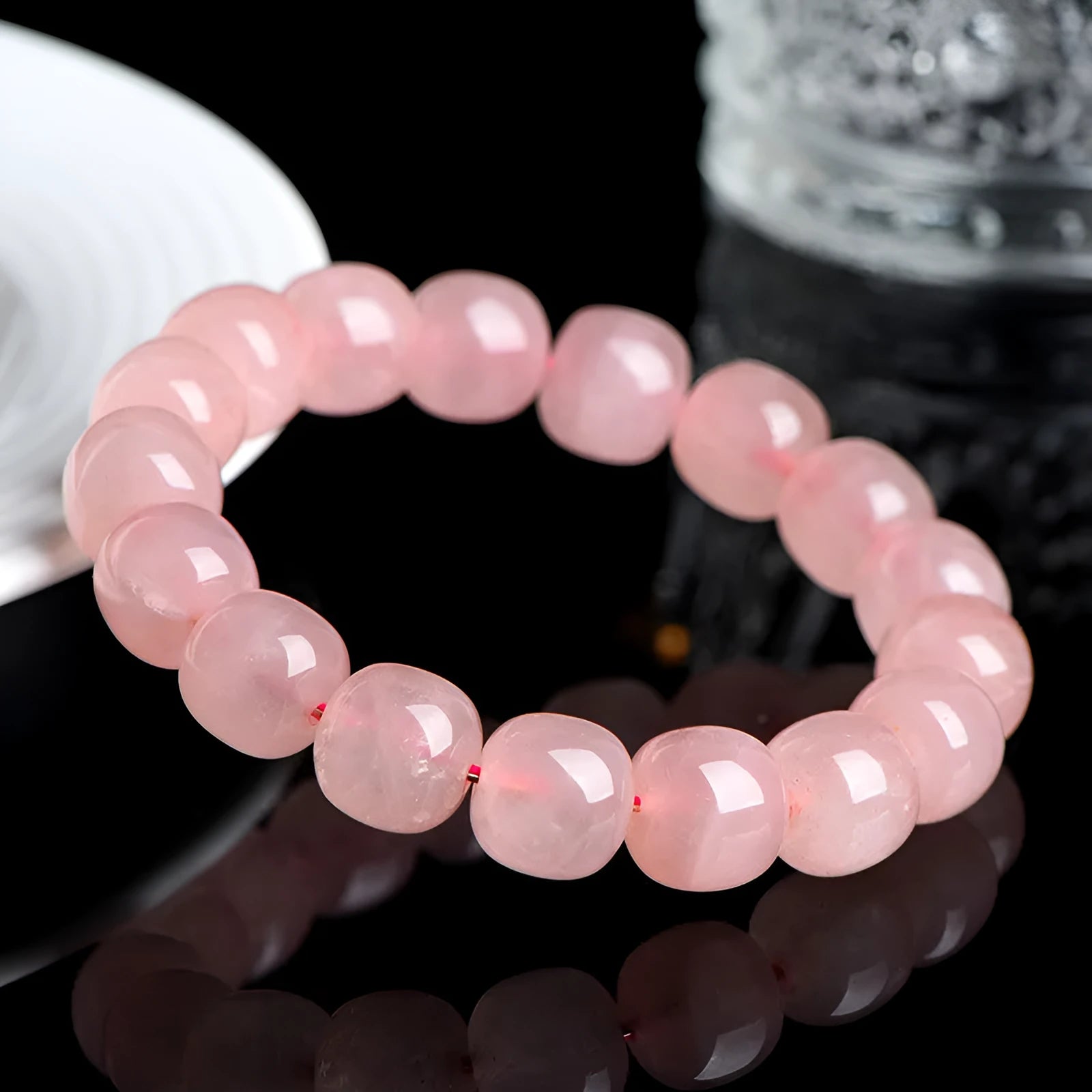 Pink natural crystal bracelet with barrel-shaped 8x10mm beads in a geometric design.