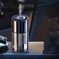 Glass AI spray perfume humidifier on a surface with USB cable, showing classic ocean fragrance option.