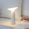Black USB rechargeable table lamp with adjustable LED reading light head on a desk.