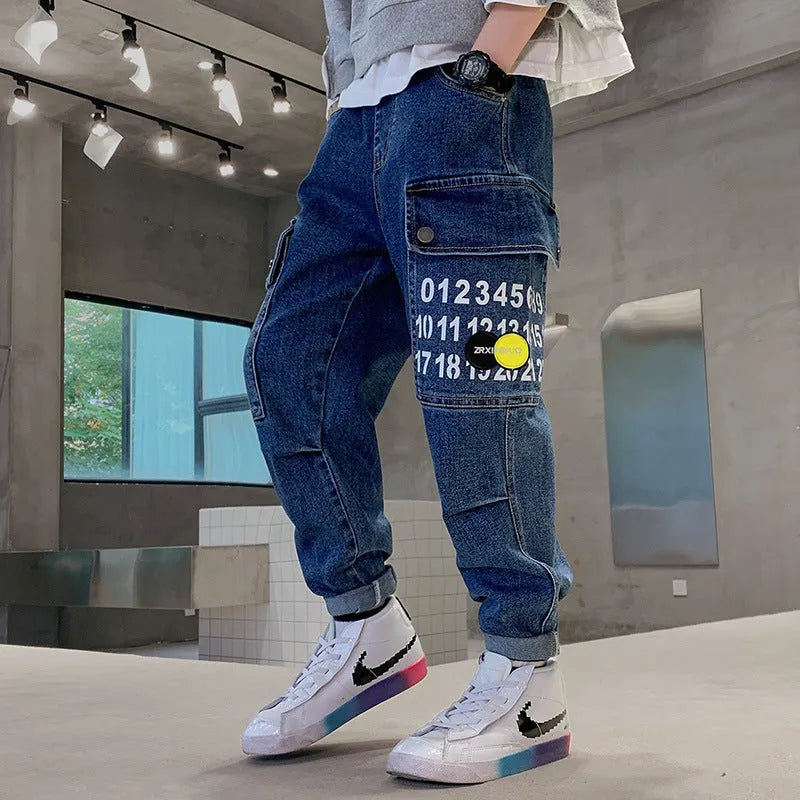 Boys printed blue cotton mid-waist girdled jeans with rubber band belt on white background