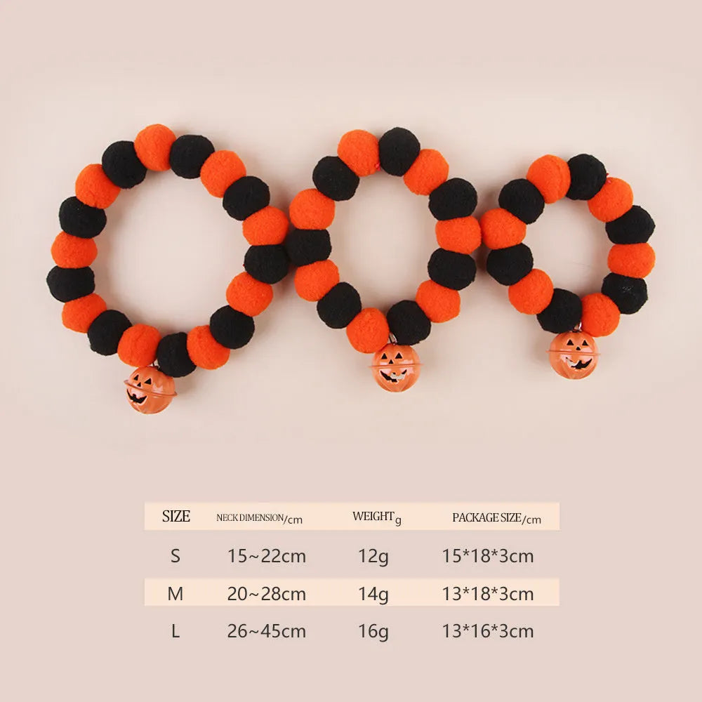 Orange pumpkin print cat collar with plastic buckle and small metal bell attached.