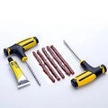 Vacuum tyre puncture repair tool kit with probe, pin, glue, and rubber strips on black background.