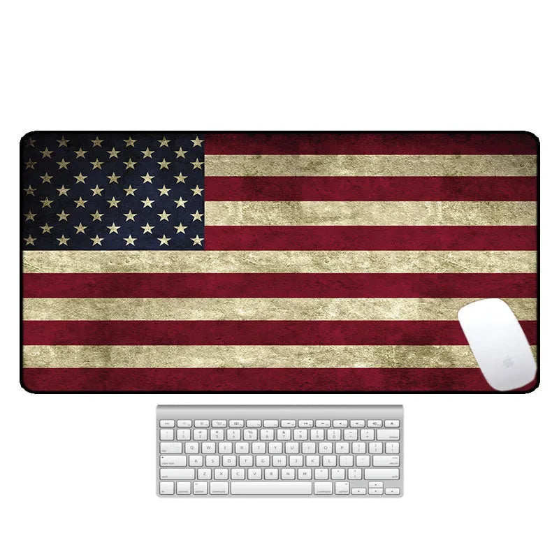 Large patterned desk mat for mouse and keyboard on a wooden desk.