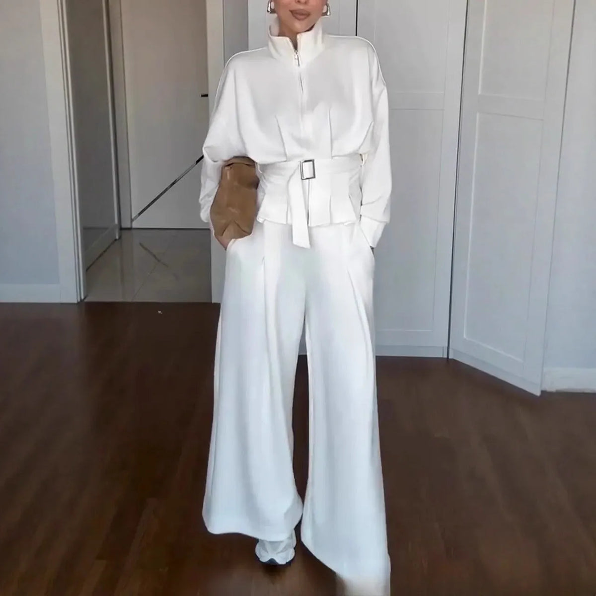 Women's polyester two-piece suit set with stand collar zip jacket and trousers, belt detail, in white dark brown or navy blue.