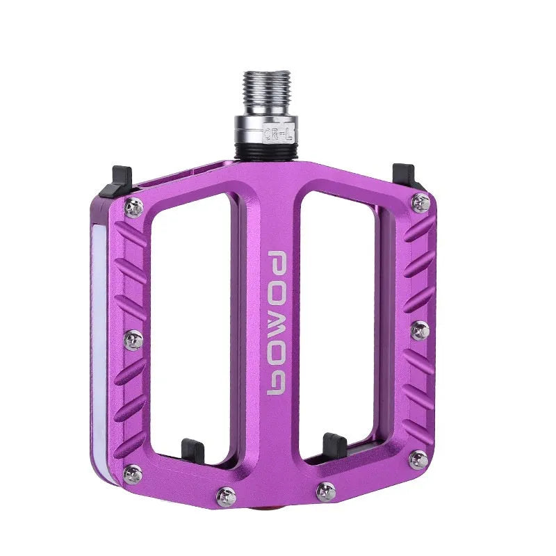 Aluminium alloy bicycle pedals with built-in LED lights in purple, black, titanium, red, and gold colour options.