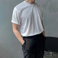 Men's slim fit cotton T-shirt in black solid colour, showing round neck and half sleeves.