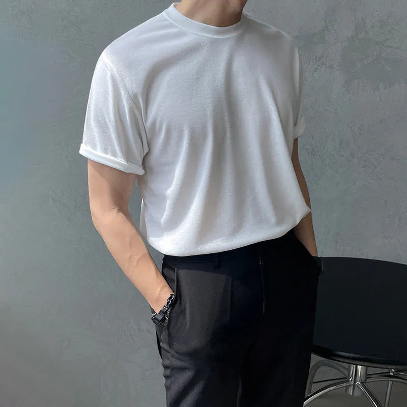 Men's slim fit cotton T-shirt in black solid colour, showing round neck and half sleeves.