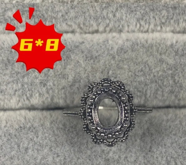 Oval open mouth copper ring with a 6*8 centre stone and five-pointed star ornament detail.