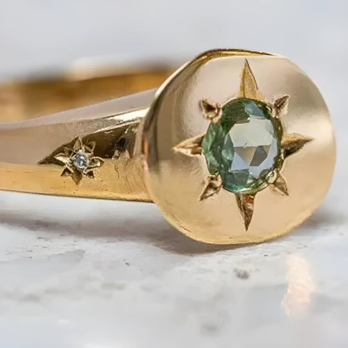 Golden adjustable ring with star design and oval asterism zircon setting