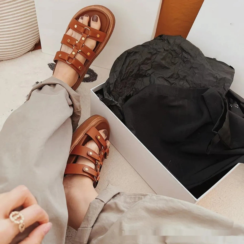 Women's Roman style sandal slippers in sheepskin with patent leather finish showing adjustable strap design