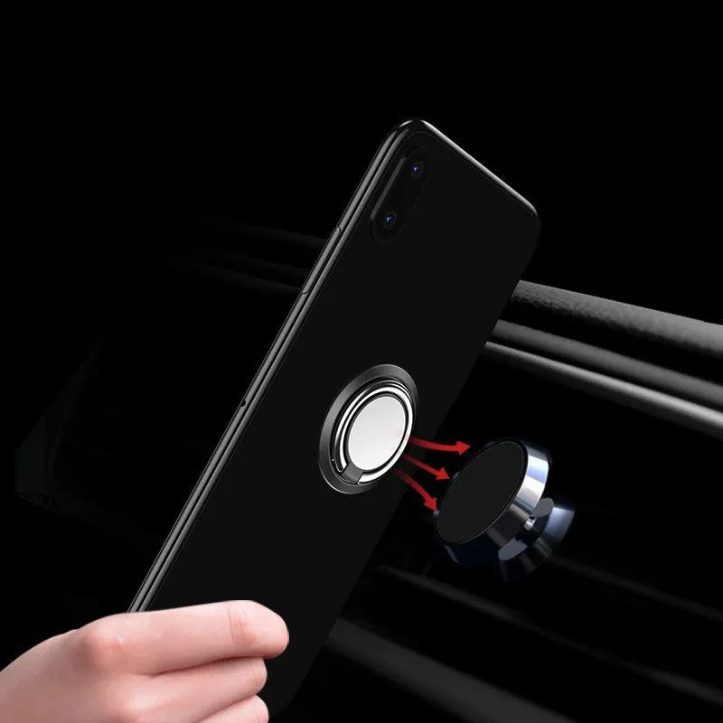 Magnetic suction ring car phone holder in black on car dashboard holding a smartphone