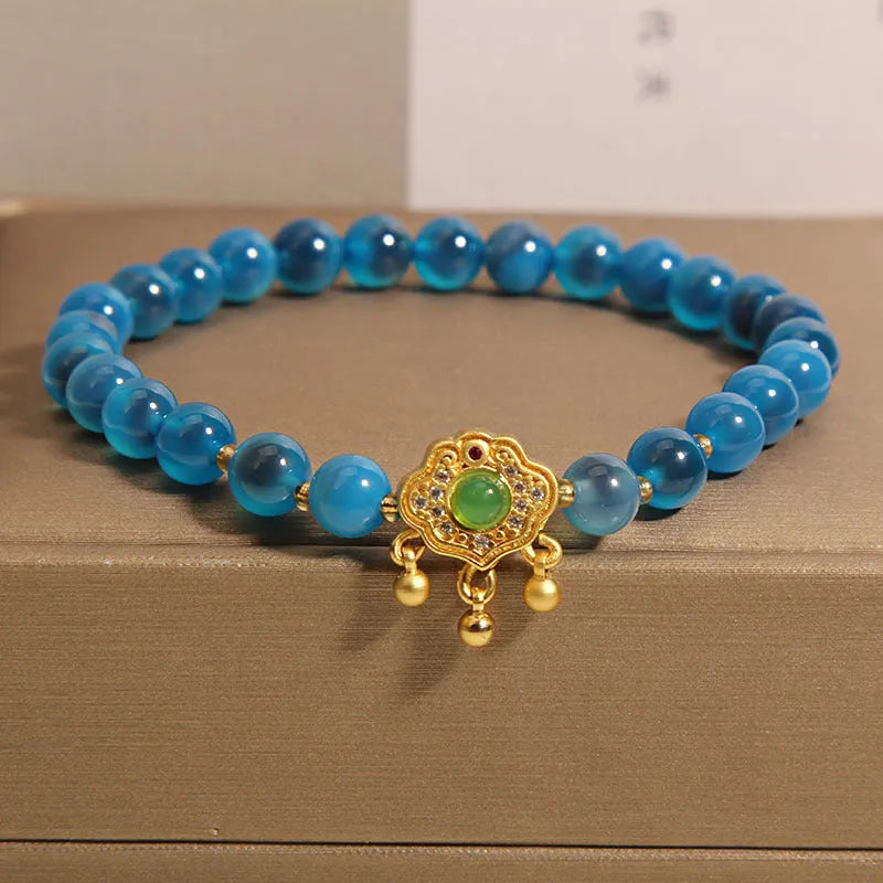 Women's blue sugar heart agate safety lock pendant bracelet with crystal and rhinestone details on alloy.