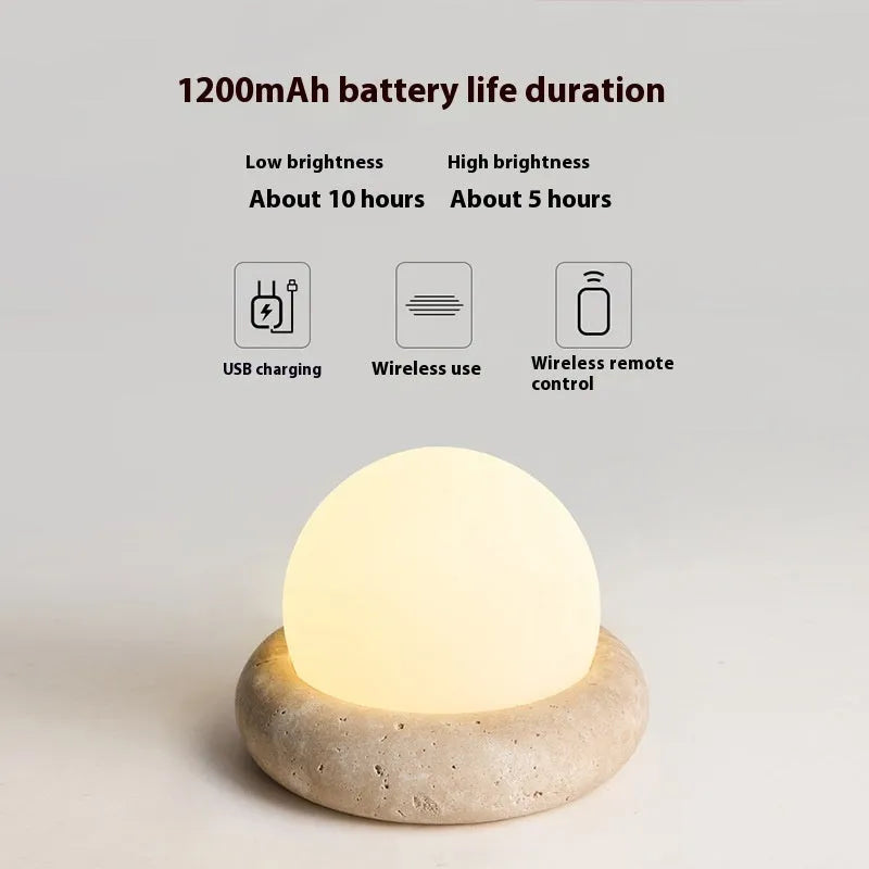 Cream style bedside night light with remote control on bedroom surface