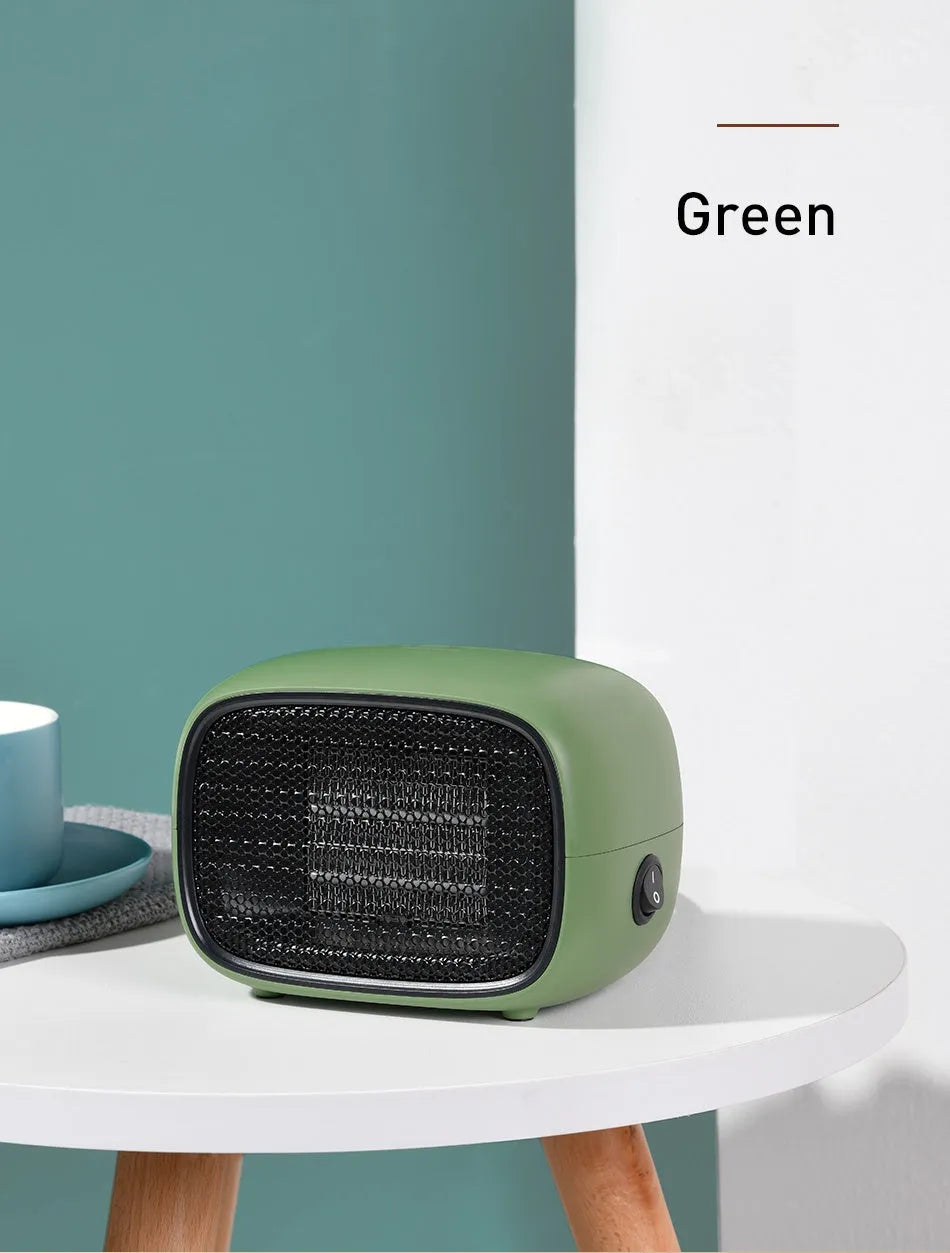 Green mini PTC ceramic heater showing compact size and metal mesh grille.