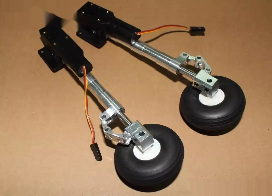 Pair of silver alloy retractable landing gear for RC models with wheels, shown at an inclined kneeling angle.