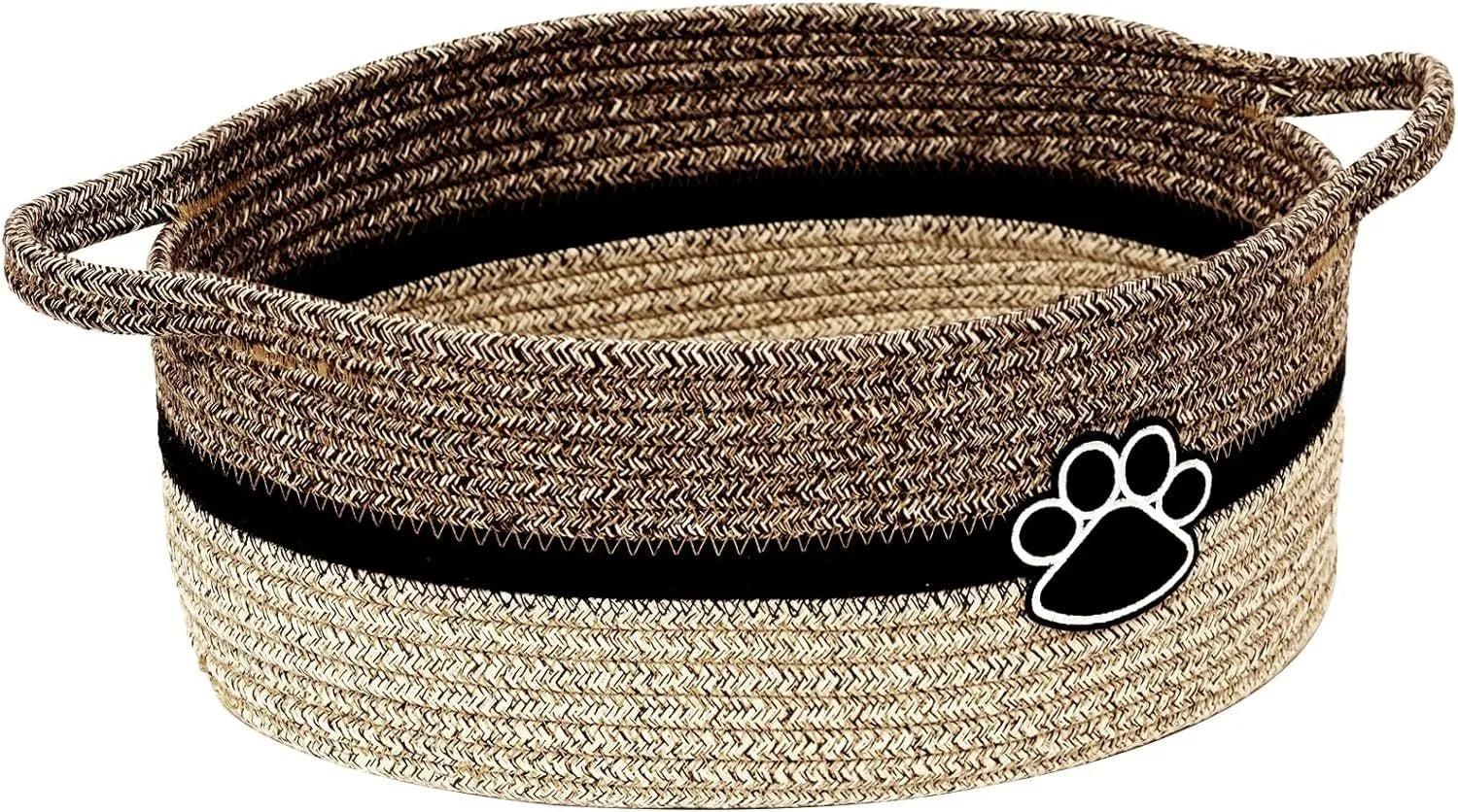 Handmade light beige woven cotton rope storage basket with a handle, shown on a wooden surface.