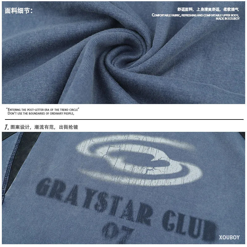 Blue men's hip hop letter print t-shirt with raglan sleeves on a hanger.