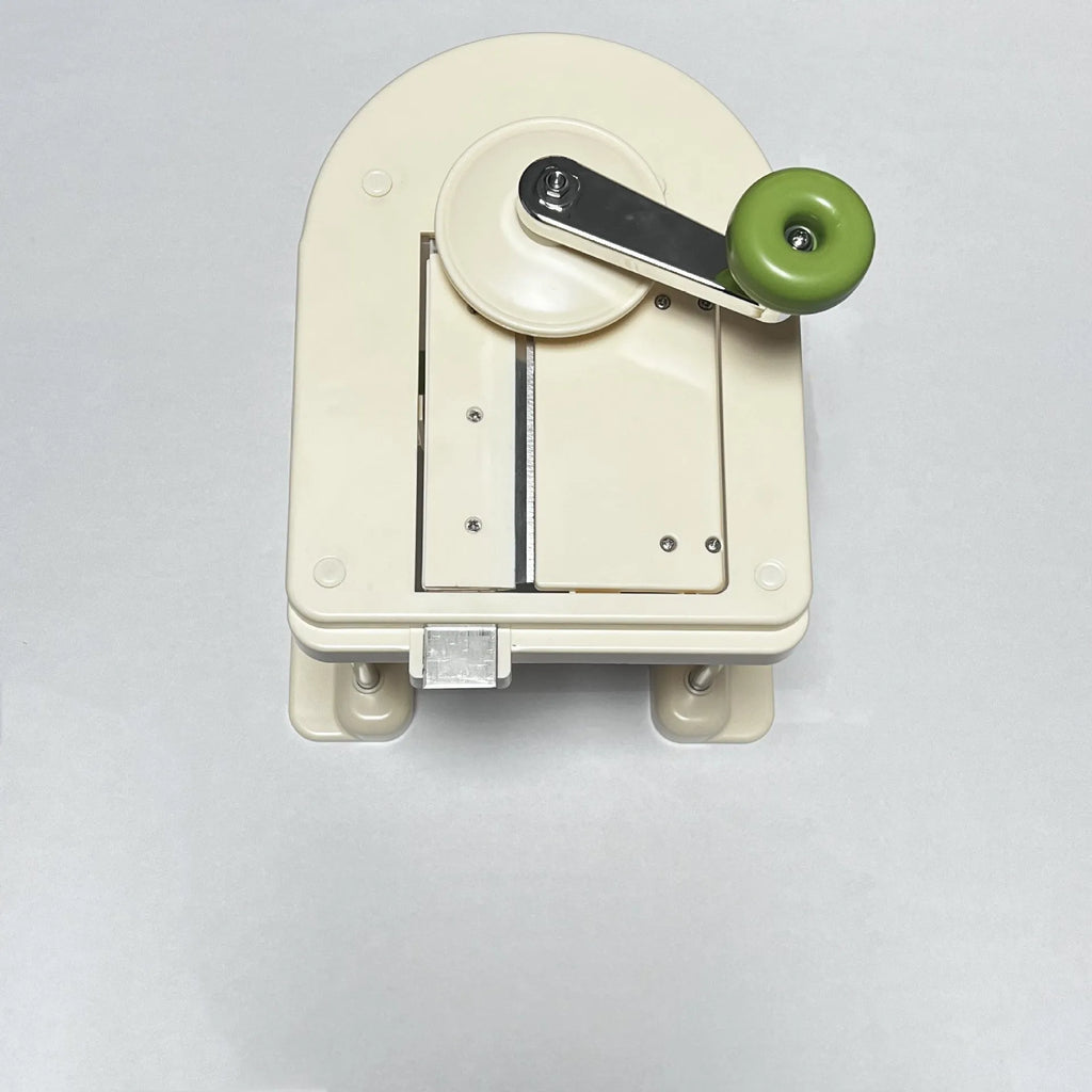 Beige-handled stainless steel vegetable slicer and grater kitchen tool