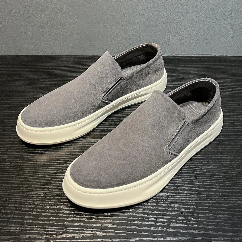 Men's casual slip-on shoes in apricot colour with round toe and mid heel, showing sewing line detail on artificial PU upper